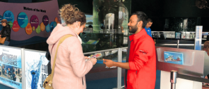 A woman interacting at Ripley’s Aquarium of Canada staff.