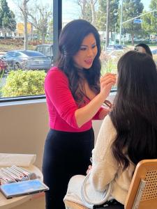 Moms received mini makeovers from Manna Kadar Cosmetics, Manna herself applies make-up to a miracle mom