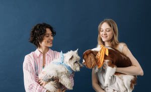 Two women holding dogs.