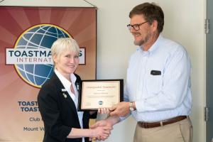 Rebecca Murray receives Distinguished Toastmaster Award from Toastmasters International.