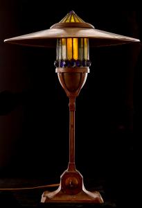 Early Tiffany table lamp signed “GDT Co.” with a center post sleeved to allow the glass shade to drop, exposing the socket and bulb, 20 inches tall (est. $18,000-$24,000).