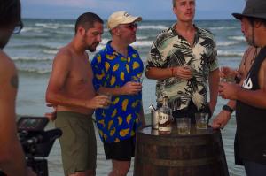 Rare Spirits Society members gather around a barrel of Samai Rum on Koh Rong Island, Cambodia, during Uncharted Territories filming