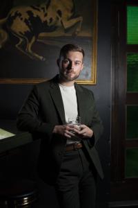 Golden Eagle Vodka Founder & CEO Dakota Blaze Rader with a snifter glass.