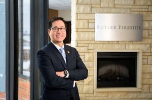 fireside portrait of Dr. Joseph Lee standing with his arms crossed