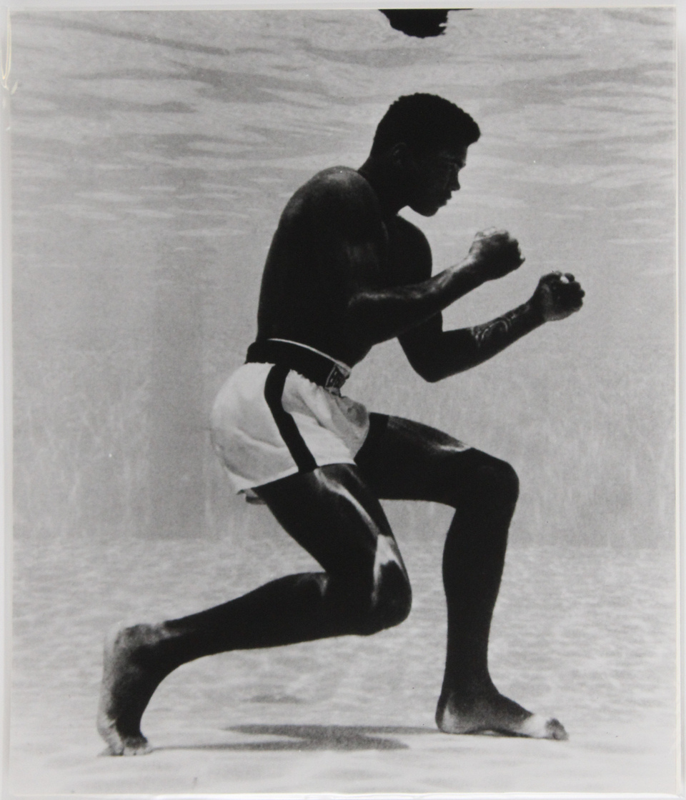 Photograph by Flip Schulke (1930-2008), titled Muhammad Ali Underwater at the Sir John Hotel Pool.