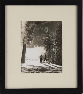 Silver gelatin photograph by Ansel Adams (American, 1902-1984), titled Two Skiers, stamped "Photographed in Yosemite by Ansel Adams" on verso.