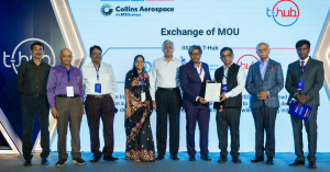 Nine people are standing side by side at an event in Hyderabad. Two are holding a memorandum of understanding between the International Institute for Space Studies and Research and T-Hub.