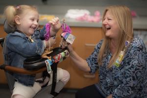 Shriners Children's nurse working with patient.