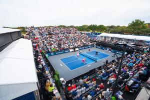 A full stadium watching pro pickleball.