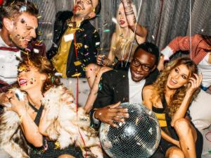 Guests celebrate and party together in a luxurious Lovenaire Portrait Lounge.