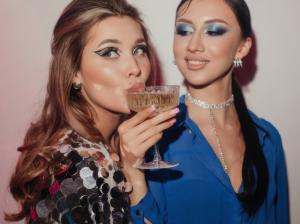 Two female guests pose inside a Lovenaire lounge at a wedding.