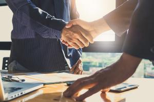 Handshake to mark the acquisition of Adapt2 by Energy Exemplar
