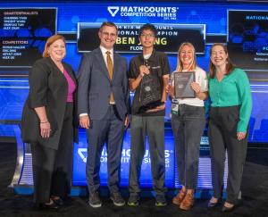 Ben holds his trophy with his coach and representatives from MATHCOUNTS.