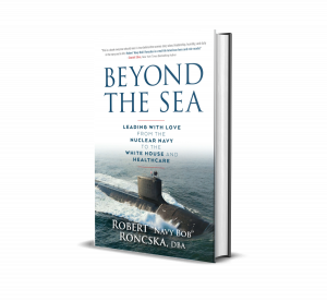 Book cover with the title, "Beyond the Sea, leading with love from the Nuclear Navy to the White House and Healthcare" by Robert "Navy Bob" Roncska, DBA. Cover picture includes a photo of a submarine surfacing in the middle of the ocean.