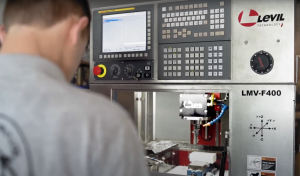 A student working with a CNC milling machine