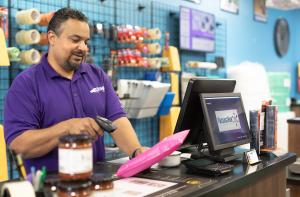 PackageHub Franchisee, Rajan Dorasami,  scans a package at his store in Ft. Worth, TX.