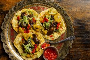An Indian style plate with trini street food doubles