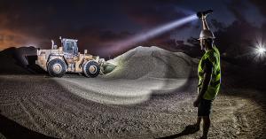 Man shining flashlight on a construction site