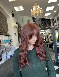 Client of Lazarou Duke Street is shown after her hair extensions appointment, long red hair.