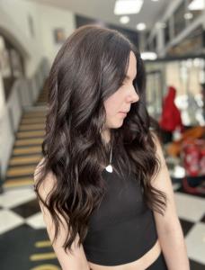 Client of Lazarou Duke Street (Cardiff Castle) in the middle of the salon following her tape hair extensions  appointment.