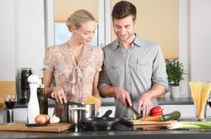 Man and woman cooking in kitchen together