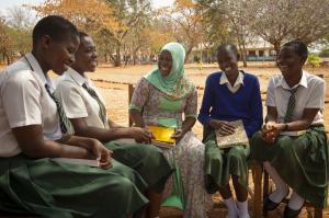 De jeunes étudiantes africaines accompagnées de leur professeur vêtues d'un foulard musulman sont assises et souriantes