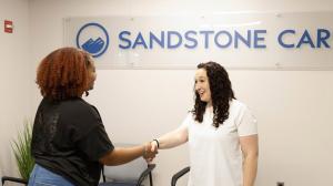 Sandstone clinician greet a client