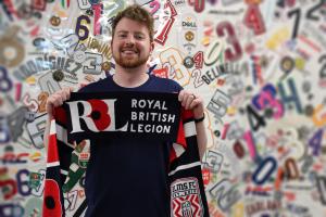 Declan Gleeson Holds RBL Scarf to Celebrate Expanded Partnership