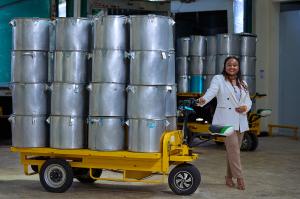 Founder and CEO Wawira Njiru pictured with large steel cooking pans