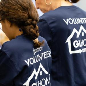 GL Homes volunteers, inspired by founder Itchko Ezratti's legacy of community service, preparing meals for homebound seniors during a charity event.