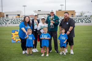 RMHC inspiration family, Fred and Fran Hill, receive the Top Community Award from featured alumni family, the McSherrys