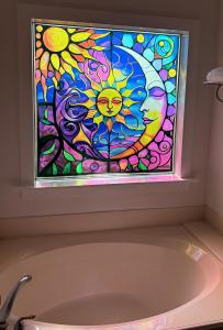 Tub window decorated with Sun art on privacy window film.