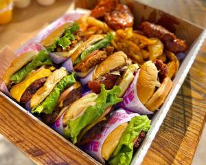 A Box filled with Burgers, Chicken Sandwiches and Fries