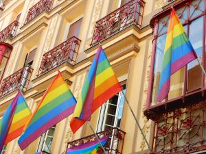 Pride flags on a building in Madrid City by Oscar