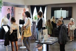 Diverse Crowds and Generations Gather at Couture Pattern Museum: Enthusiastic visitors of all ages, including passionate fashion students from universities across the region, attend the record-breaking James Galanos exhibition at the Couture Pattern Museu