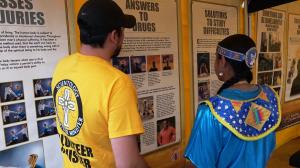 This is a volunteer minister showing one of the many panels to an attendee of the free courses.