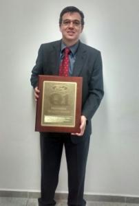 Mr. Eduardo Correa holding the Ford Q1 Award