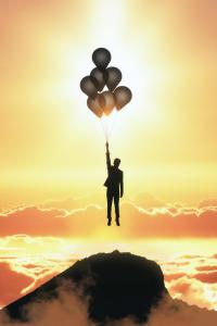 Insurance agent being elevated by balloons signifying a lift in their career.