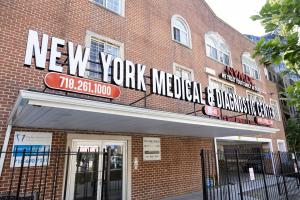 Front exterior view of New York Medical and Diagnostic Center in Kew Gardens, NYC, with prominent signage and contact number