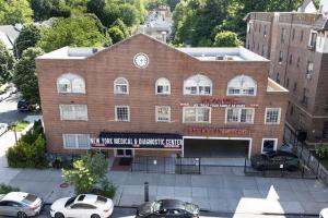 Aerial view of New York Medical and Diagnostic Center building, surrounded by trees and residential buildings.