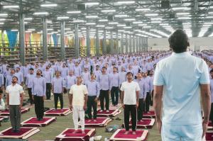 Savji Dholakia and Hari Krishna Exports team doing yoga on International Yoga Day 2024