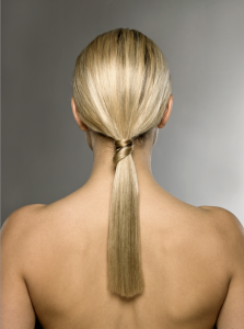 person with long blonde hair, hair styled in a low ponytail