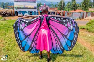 A participant showcases her butterfly attire ahead of a virtual Grand Butterfly Gathering event in Kenya.