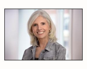 Head and shoulder image of Girls Know How author, a woman with grey shoulder-length hair