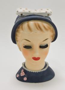 Relco lady head vase, 7 inches tall, having a nick to the base of the rim. Estimate: $400-$600; minimum bid $1.