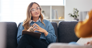 A friendly therapist listening to a patient during a session.