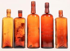 Five circa 1900-1920 Lash’s Bitters bottles (San Francisco), five different tooled top varieties of the 18 listed by Ring-Ham, with two of the five having the original paper labels (est. $240-$375).