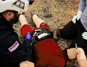 Emergency responders demonstrate the application of the AAJT-S on a training mannequin during a field exercise.