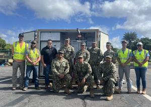  group of people standing in front of HOTPOD container