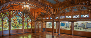 An ornate room with stained glass and intricate woodwork at the Dossin Great Lakes Museum.